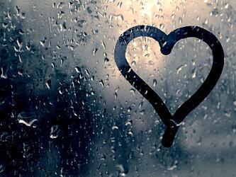 heart drawn on rainy steamed up window